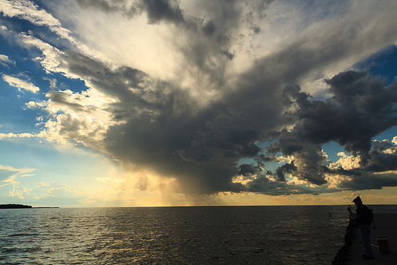 Fishing Under Dramatic Skies
